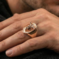 Load image into Gallery viewer, Rose gold plated bull signet ring on finger, close-up lifestyle photo showcasing the shield-shaped top and engraved bull details
