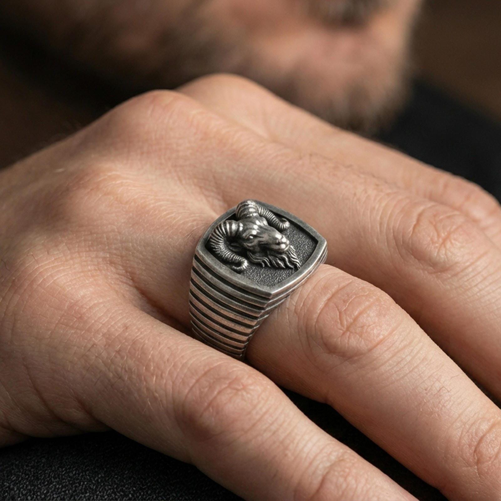 Oxidized ram signet ring worn on finger, masculine biker style ring lifestyle shot