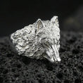 Load image into Gallery viewer, Polished silver wolf ring on volcanic stone, 3D animal head design with premium studio lighting
