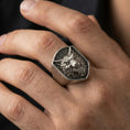 Load image into Gallery viewer, Oxidized angry wolf ring worn on finger, rugged masculine style with wolf head centerpiece
