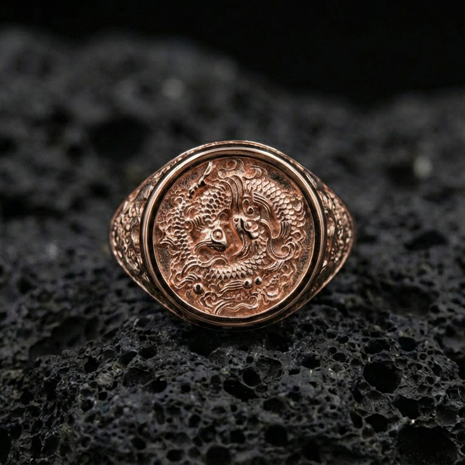 Rose gold plated koi fish ring on volcanic rock, sharp macro product photo showcasing the round face with koi and flowing water design