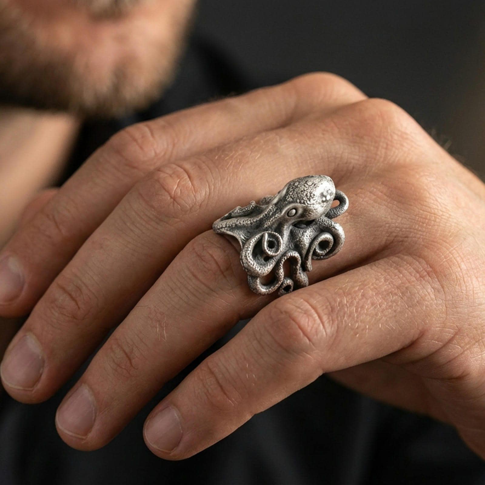 Oxidized octopus ring worn on finger, lifestyle close-up focusing on the sculpted head and curled tentacles for a bold statement look