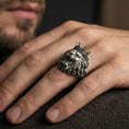 Load image into Gallery viewer, Oxidized crowned lion ring worn on finger, lifestyle close-up focusing on the roaring lion face, crown detail, and heavy mane texture
