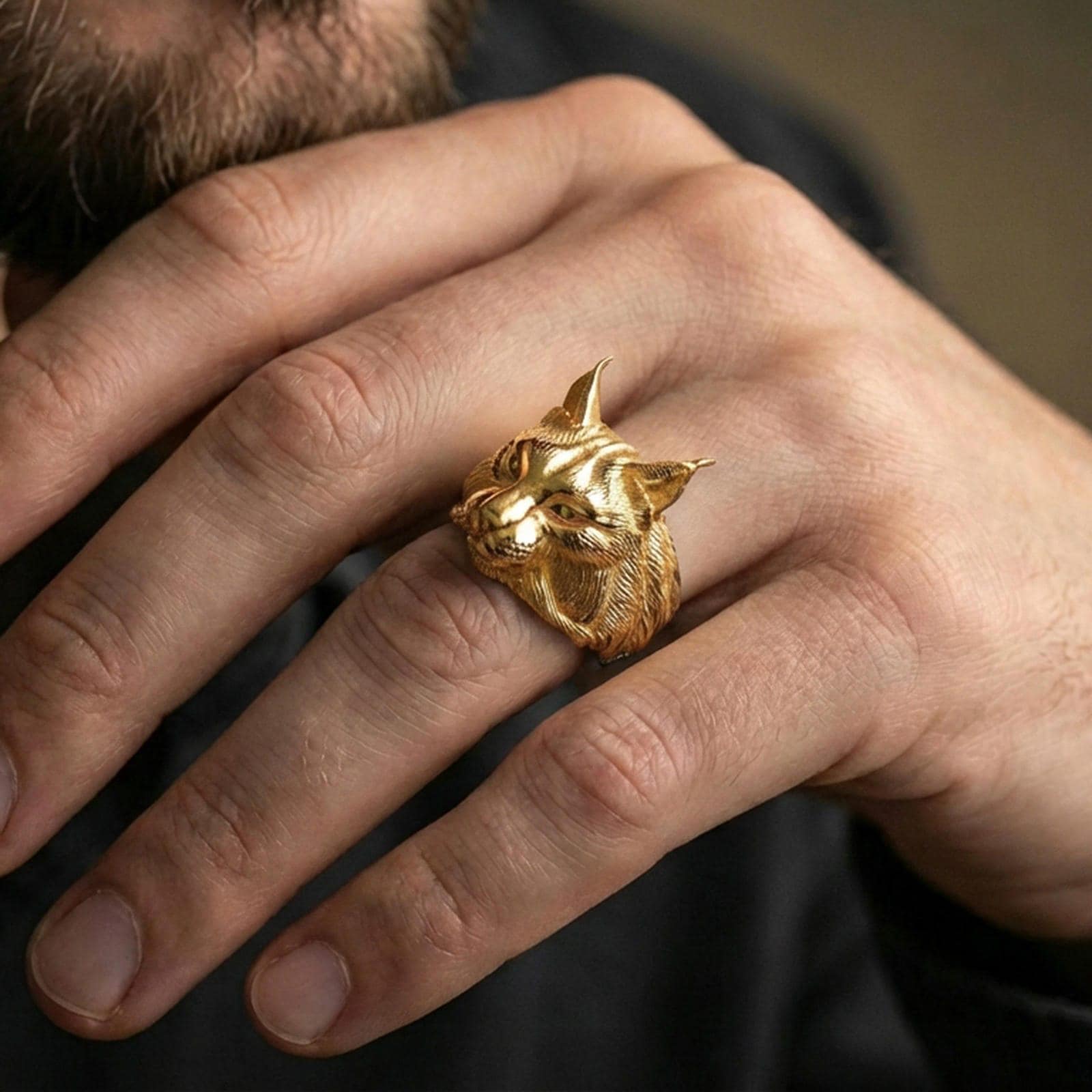 Gold plated lynx ring worn on finger, lifestyle wear shot emphasizing the wild cat head design and textured fur engraving