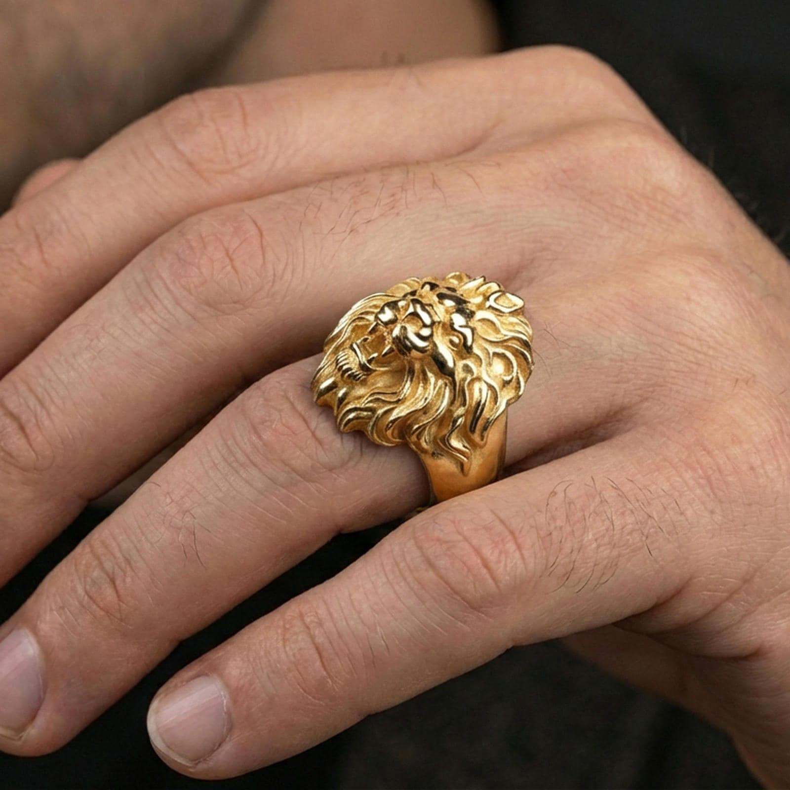 Gold plated lion signet ring worn on finger, powerful animal totem jewelry aesthetic
