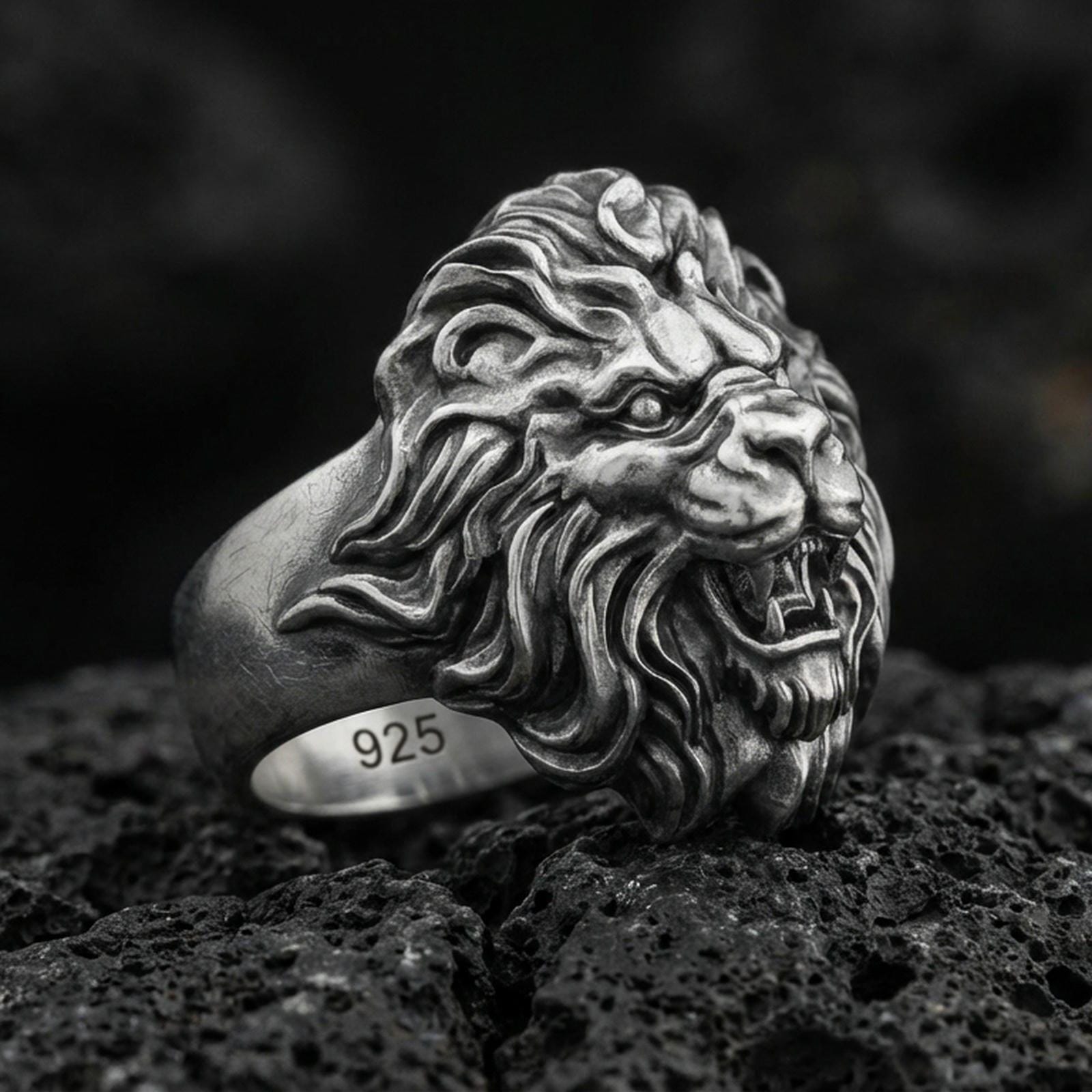 Oxidized sterling silver roaring lion ring on volcanic rock, macro closeup with deep contrast details