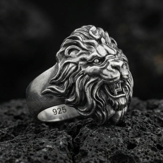 Oxidized sterling silver roaring lion ring on volcanic rock, macro closeup with deep contrast details