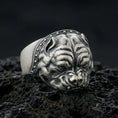 Load image into Gallery viewer, Oxidized sterling silver bulldog head ring on textured volcanic rock, macro close-up showing intense facial wrinkles and studded collar detail
