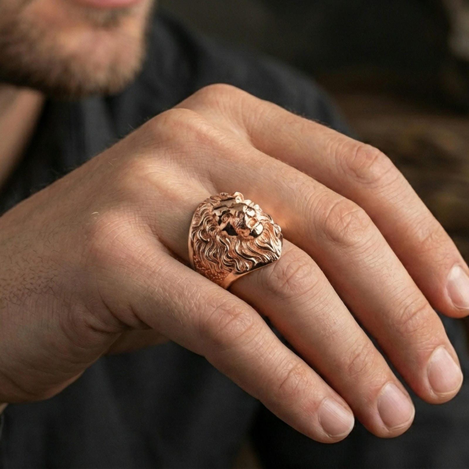 Rose gold plated lion ring on finger, close-up lifestyle photo showcasing the roaring lion face, mane curls, and premium finish look