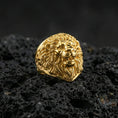 Load image into Gallery viewer, Gold plated lion head ring on porous volcanic stone, premium dark studio shot emphasizing the bold mane relief and fierce animal expression
