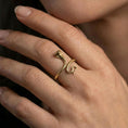 Load image into Gallery viewer, Gold plated cobra snake ring worn on finger, lifestyle wear shot emphasizing the bold upright cobra design and coiled tail detail
