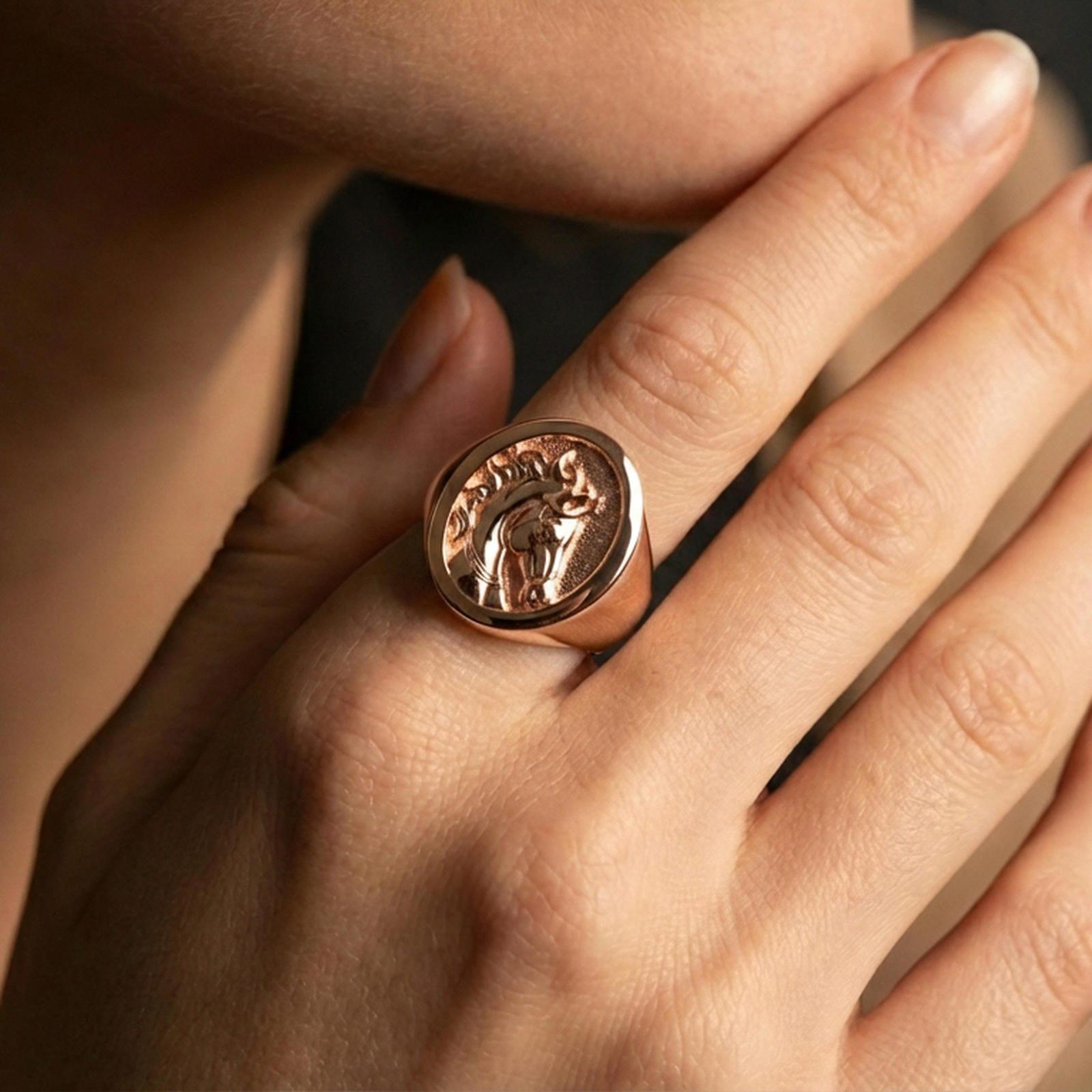 Rose gold plated horse ring on finger, close-up lifestyle photo showcasing the round face, detailed horse head engraving, and premium finish look