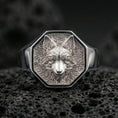 Load image into Gallery viewer, Front view of a polished silver fox head signet ring on textured volcanic rock with premium macro lighting
