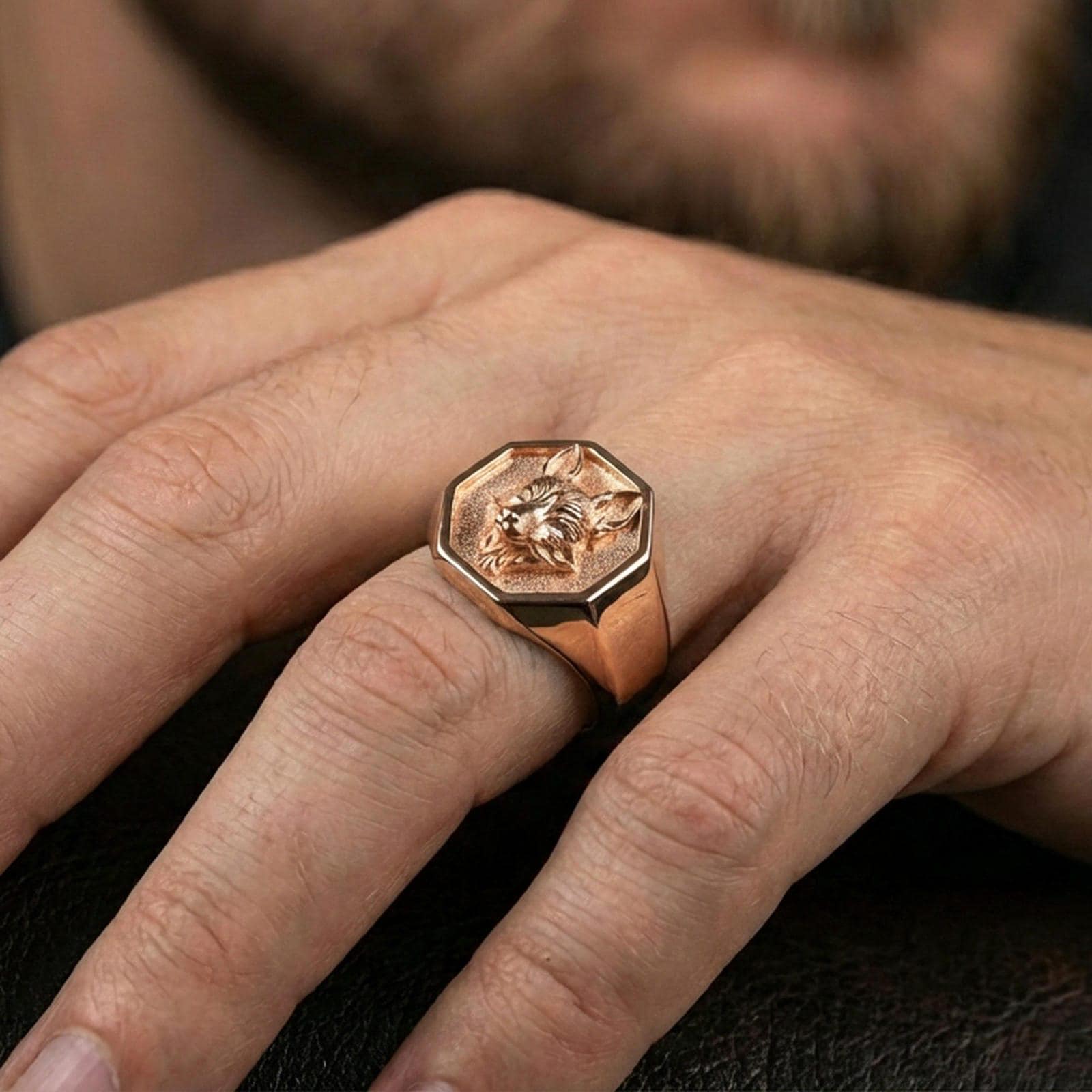 Rose gold plated fox head signet ring on a finger, premium close-up emphasizing the sculpted animal detail