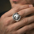 Load image into Gallery viewer, Polished silver horseshoe ring on finger, natural hand pose highlighting the equestrian horse head relief and clean open-frame silhouette
