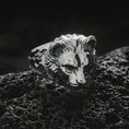 Load image into Gallery viewer, Polished silver lioness ring displayed on textured volcanic rock with sharp macro detail and soft shadows
