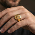 Load image into Gallery viewer, Gold plated lion signet ring worn on finger, lifestyle wear shot focusing on the statement lion emblem and strong masculine look

