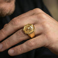 Load image into Gallery viewer, Gold plated geometric wolf ring worn on a finger against a dark minimal background, bold masculine styling
