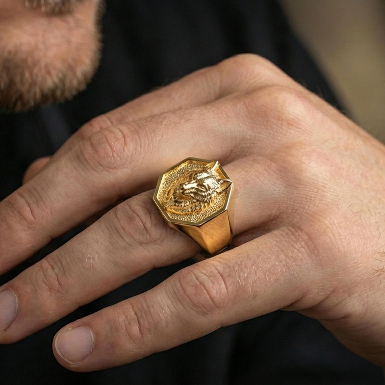 Gold plated geometric wolf ring worn on a finger against a dark minimal background, bold masculine styling