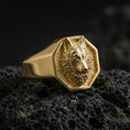 Load image into Gallery viewer, Gold plated octagon wolf signet ring on black volcanic rock, close-up emphasizing the sculpted fur texture
