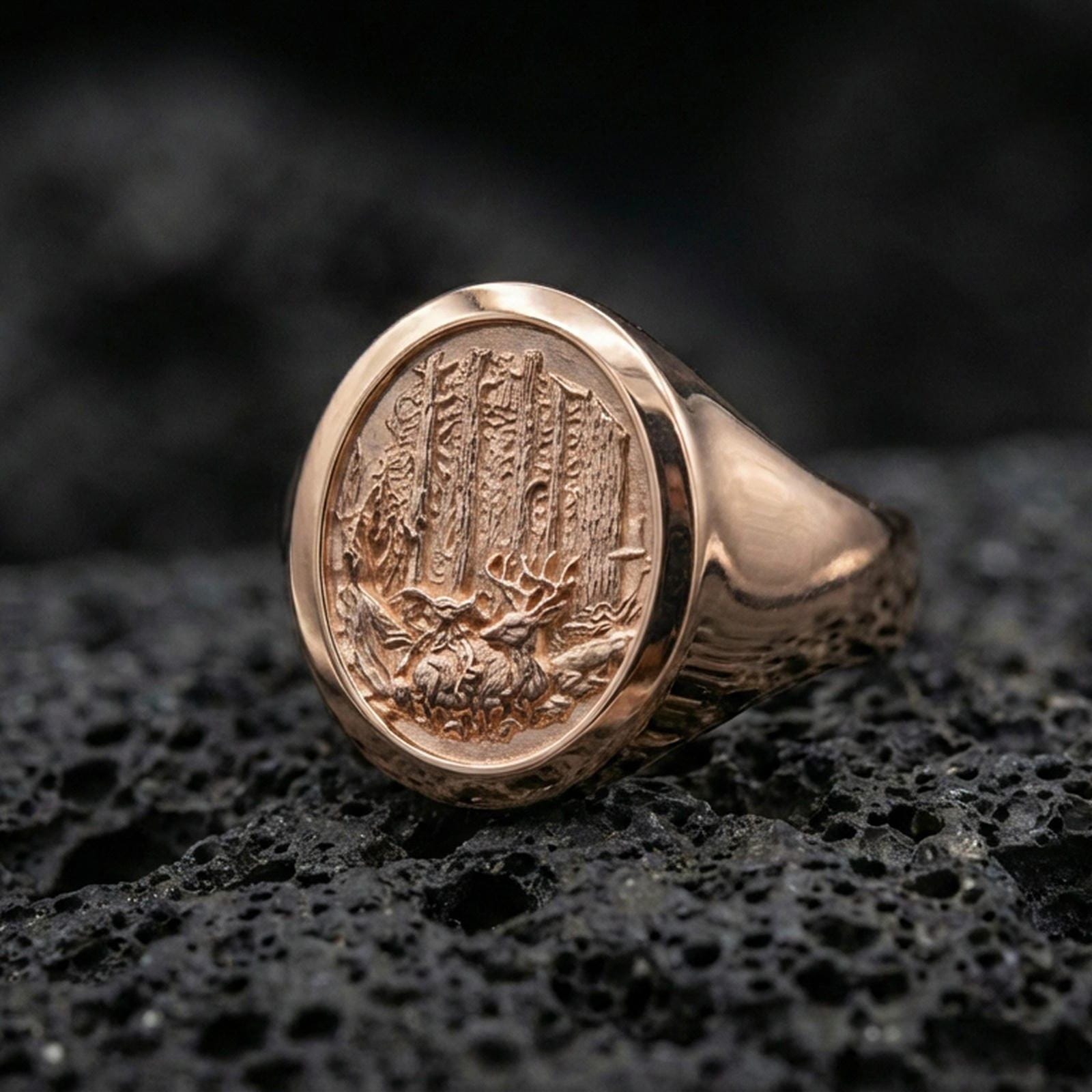 Rose gold plated woodland engraved ring on porous volcanic rock, premium studio lighting and shallow depth