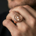 Load image into Gallery viewer, Rose gold plated Medusa ring on finger, myth-inspired signet design with Greek key edge and gorgon portrait

