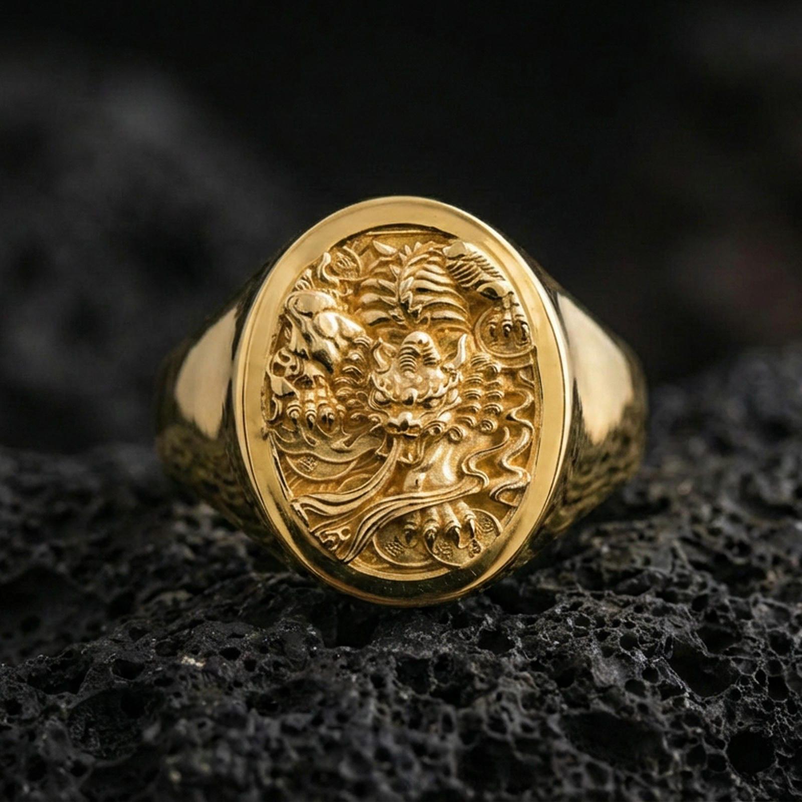 Gold Plated: Gold plated signet ring with bold carved demon/dragon motif on volcanic rock, premium macro product photo