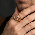 Load image into Gallery viewer, Rose gold plated Foo Dog signet ring on finger, ornate guardian lion relief detail, lifestyle wear photo
