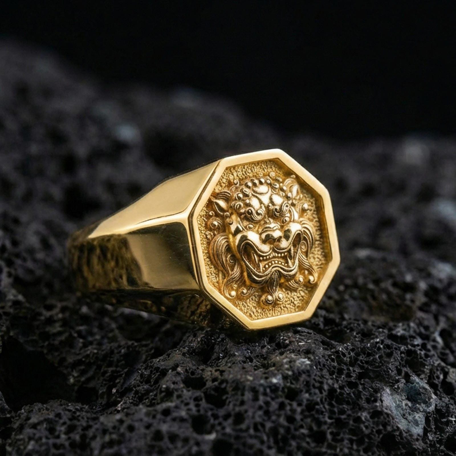 Octagon gold plated Foo Dog signet ring on volcanic rock, bold Chinese guardian lion design, premium macro product image