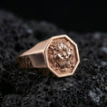Load image into Gallery viewer, Octagon rose gold plated Foo Dog signet ring on volcanic rock, ornate guardian lion face relief, luxury studio close-up
