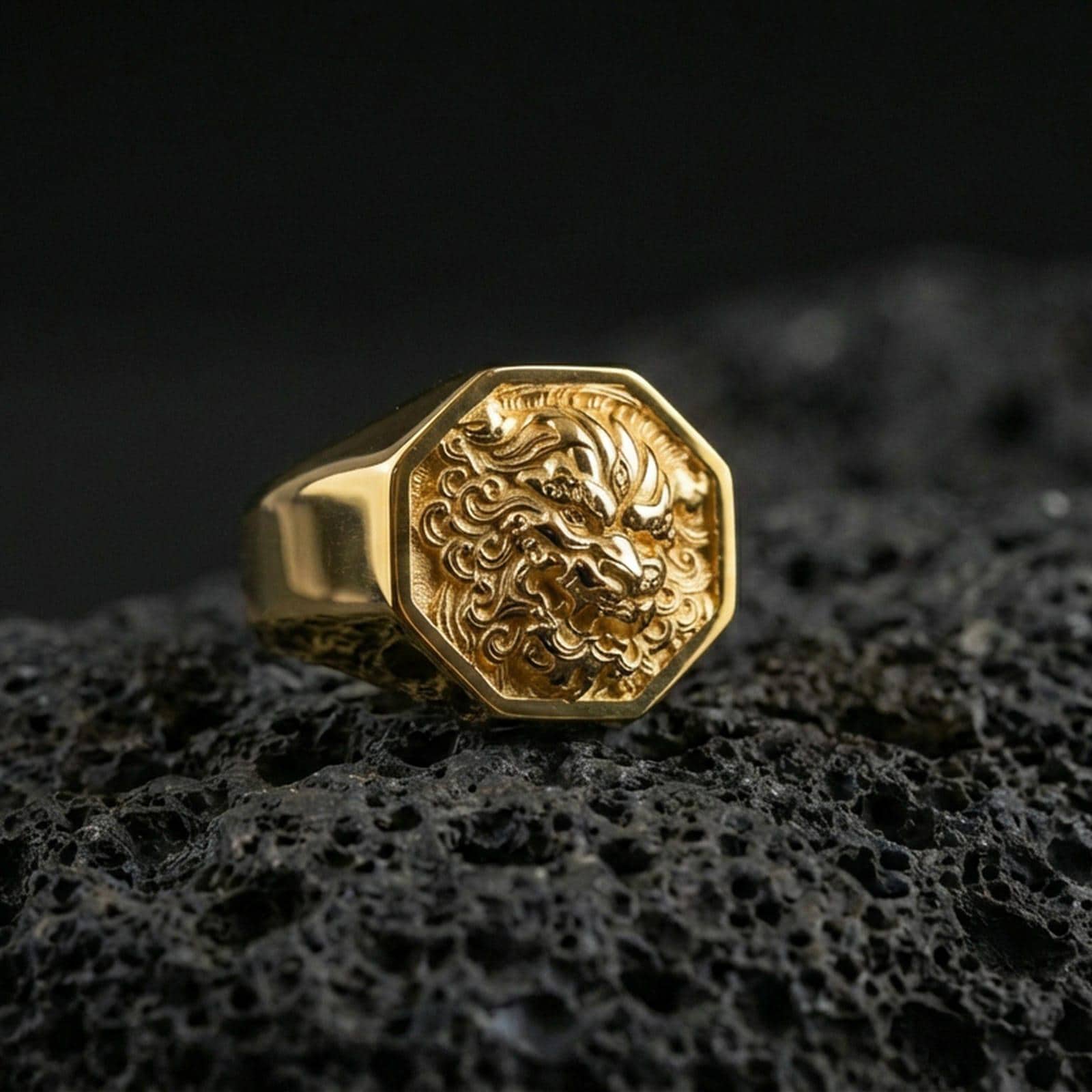 Octagon Foo Dog signet ring in a gold plated finish on volcanic rock, bold Chinese lion face design, premium macro product image