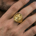 Load image into Gallery viewer, Freya Viking ring in a gold plated finish worn on finger, oval signet goddess design, masculine lifestyle close-up

