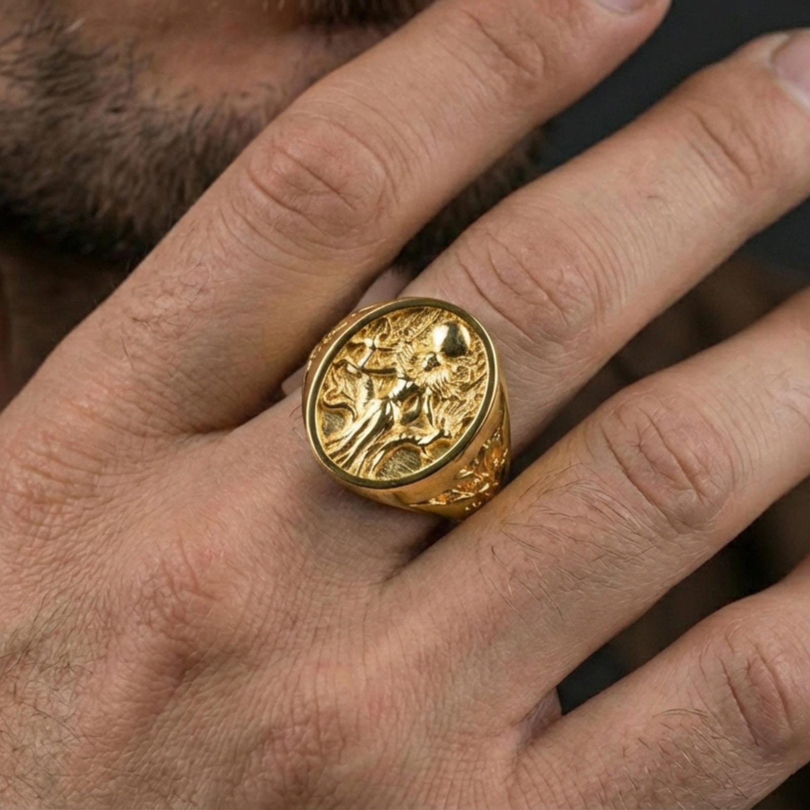 Freya Viking ring in a gold plated finish worn on finger, oval signet goddess design, masculine lifestyle close-up