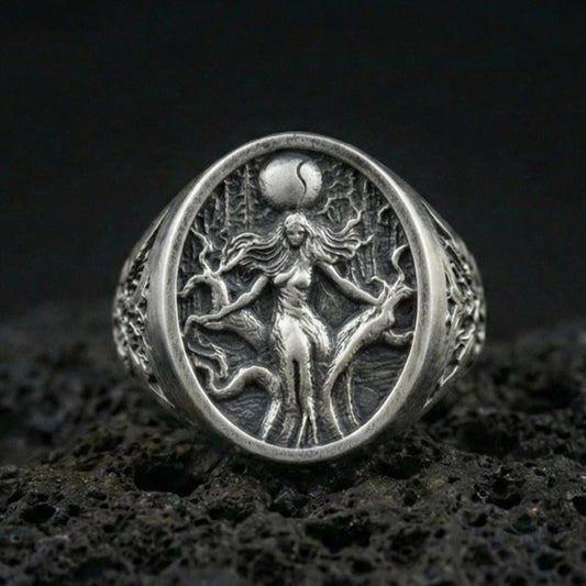 Sterling silver Freya Viking ring in an oxidized finish on volcanic rock, Norse goddess figure engraving, macro studio product shot