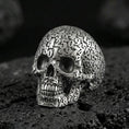 Load image into Gallery viewer, 925 sterling silver numerology skull signet ring in an oxidized finish on volcanic rock, Cronus-inspired memento mori design, macro studio shot
