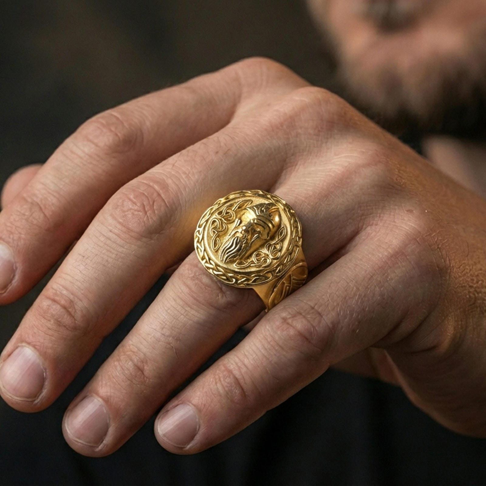 Odin the All-Father ring in a gold plated finish worn on finger, bold Valhalla Viking design, masculine lifestyle close-up