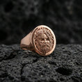Load image into Gallery viewer, Oval Odin Norse mythology signet ring in a rose gold plated finish on volcanic rock, detailed Odin face engraving, luxury studio close-up
