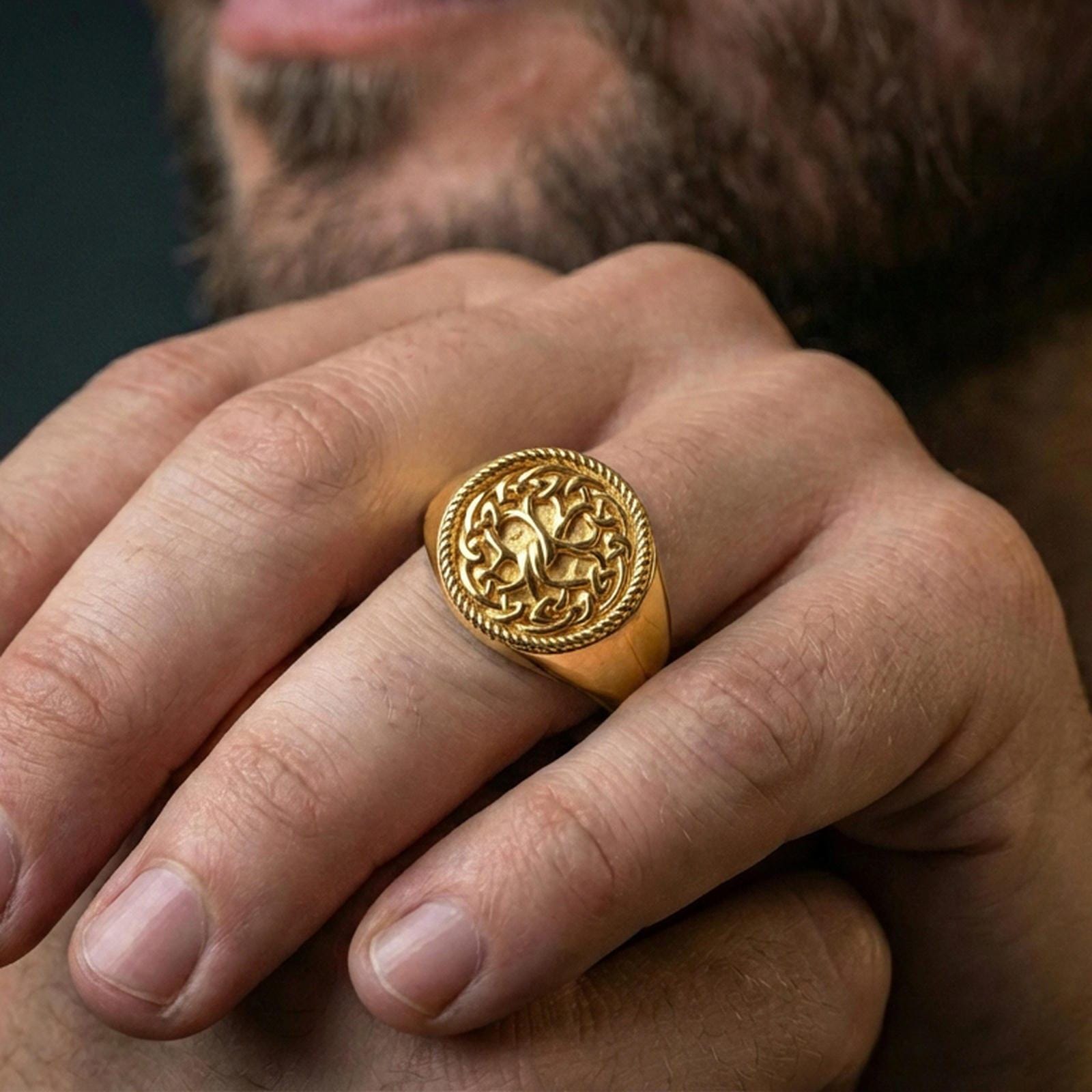 Yggdrasil Tree of Life ring in a gold plated finish worn on finger, bold Viking knotwork statement design, masculine lifestyle close-up