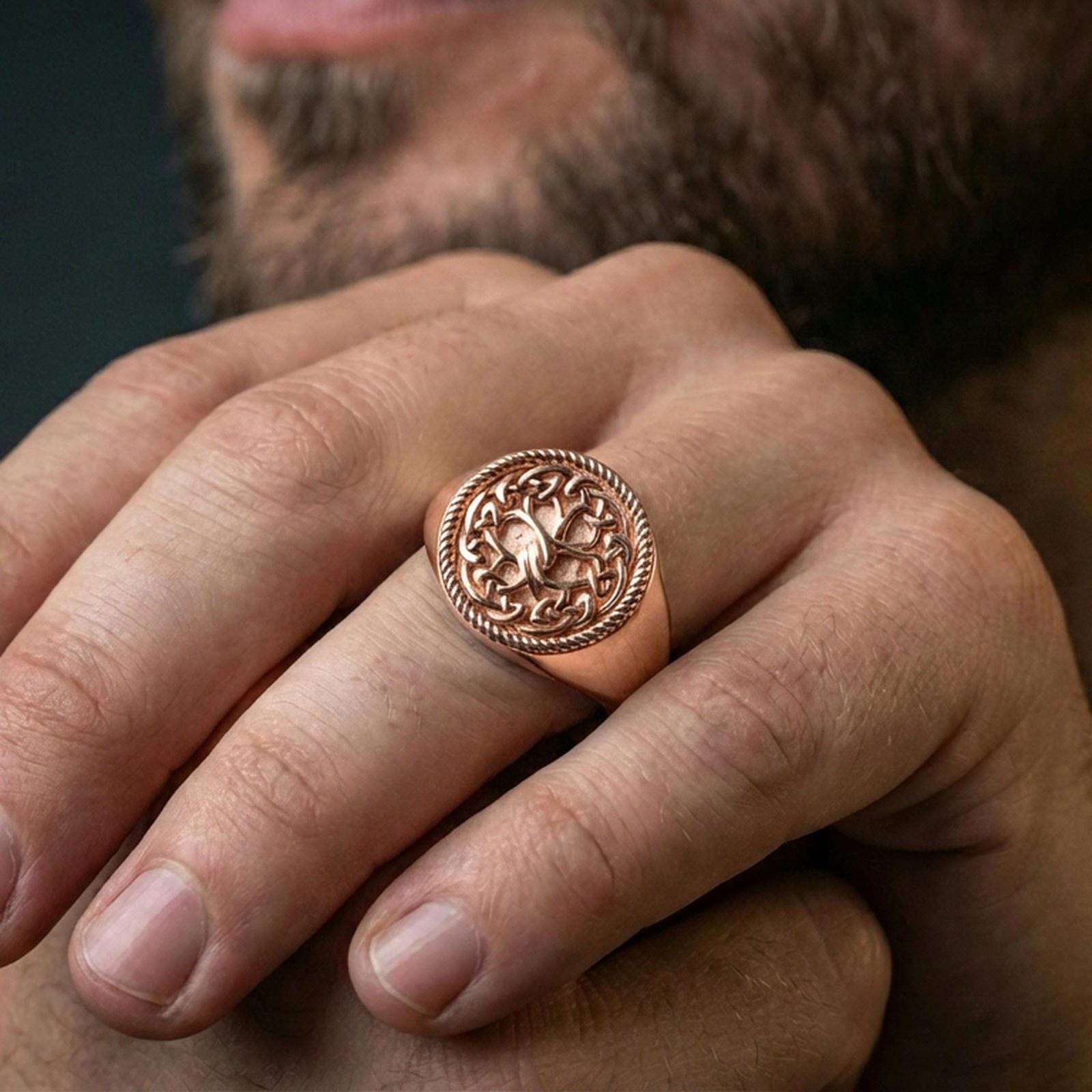 Yggdrasil ring in a rose gold plated finish on finger, detailed Tree of Life knot pattern, lifestyle wear photo