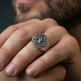 Load image into Gallery viewer, Sterling silver Yggdrasil ring in an oxidized finish worn on finger, Tree of Life knotwork design visible, lifestyle hand close-up
