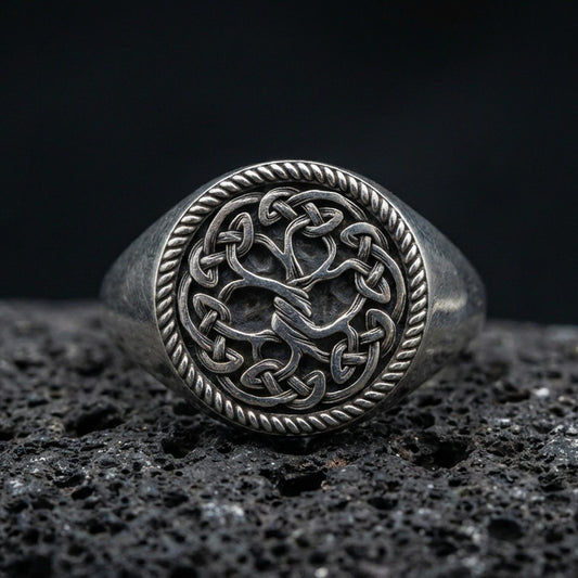 Sterling silver Yggdrasil Tree of Life ring in an oxidized finish on volcanic rock, Celtic knotwork circle with rope border, macro studio product shot