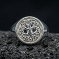 Load image into Gallery viewer, Sterling silver Yggdrasil ring in polished silver finish on volcanic rock, Norse Tree of Life motif with braided frame, close-up photo
