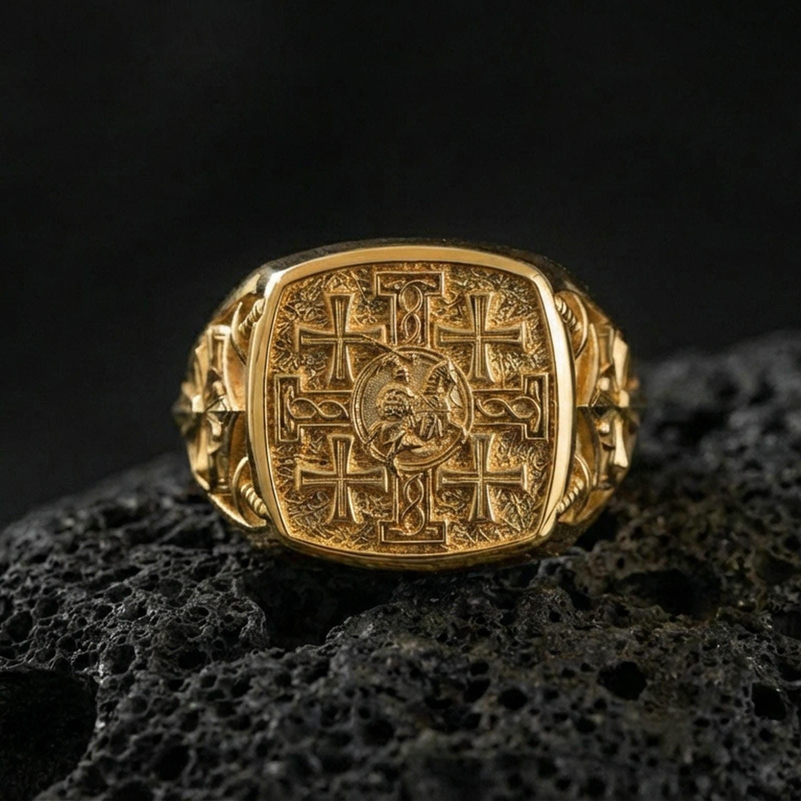 Jerusalem Cross ring in a gold plated finish on volcanic rock, crusader cross signet face with engraved details, premium macro product image