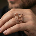 Load image into Gallery viewer, Dragon turtle ring in a rose gold plated finish on finger, ornate Eastern dragon turtle sculpture, lifestyle wear photo
