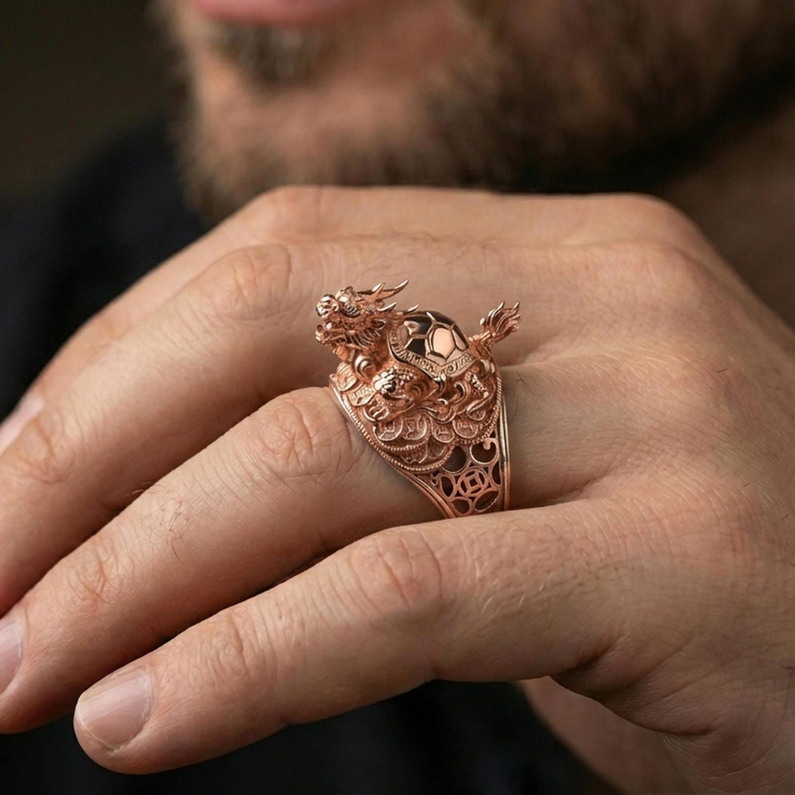 Dragon turtle ring in a rose gold plated finish on finger, ornate Eastern dragon turtle sculpture, lifestyle wear photo
