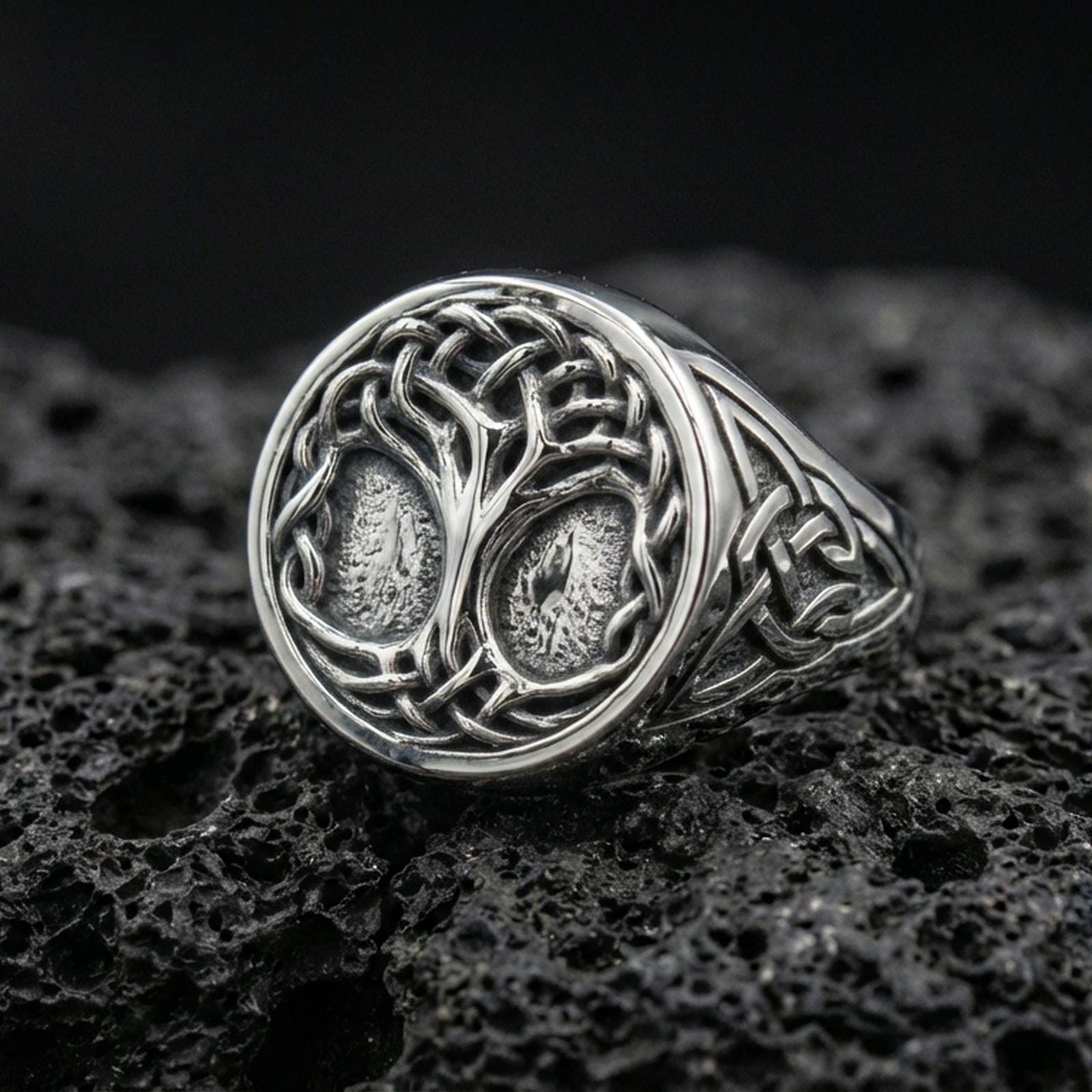 Sterling silver Tree of Life signet ring in polished silver finish on volcanic rock, Celtic knot details with textured background, close-up photo