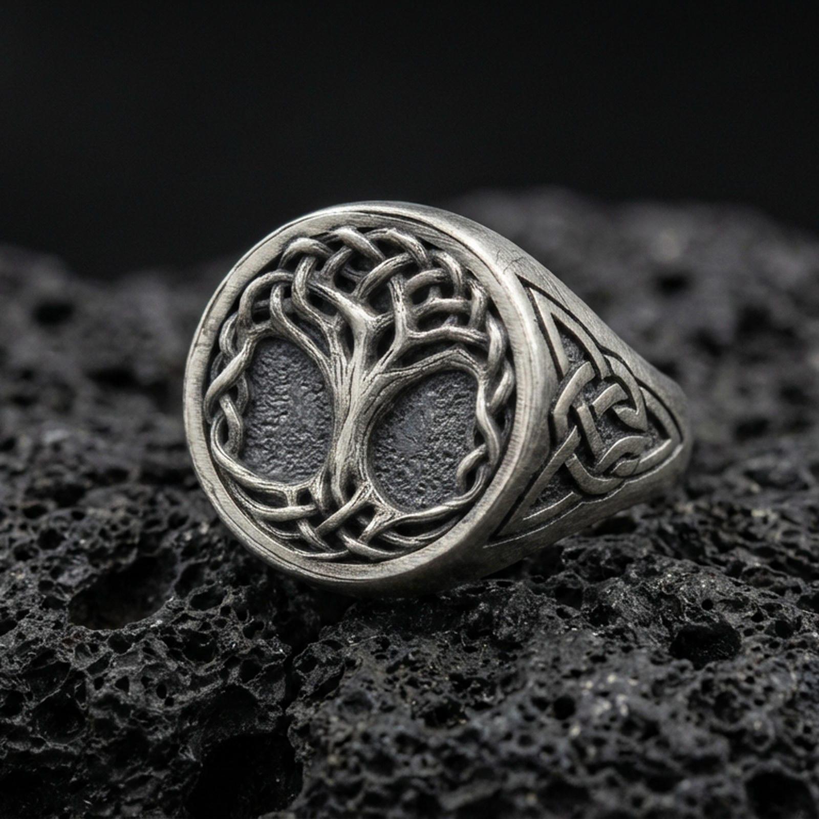 Sterling silver Celtic Yggdrasil Tree of Life ring in an oxidized finish on volcanic rock, braided branches and knotwork band, macro studio product shot