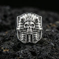 Load image into Gallery viewer, Sterling silver pharaoh skull ring in polished silver finish on volcanic rock, detailed Egyptian headdress and skull carving, close-up photo
