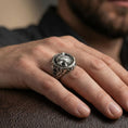 Load image into Gallery viewer, Sterling silver Fenrir wolf ring in an oxidized finish worn on finger, snarling wolf face detail and side engravings visible, lifestyle hand close-up
