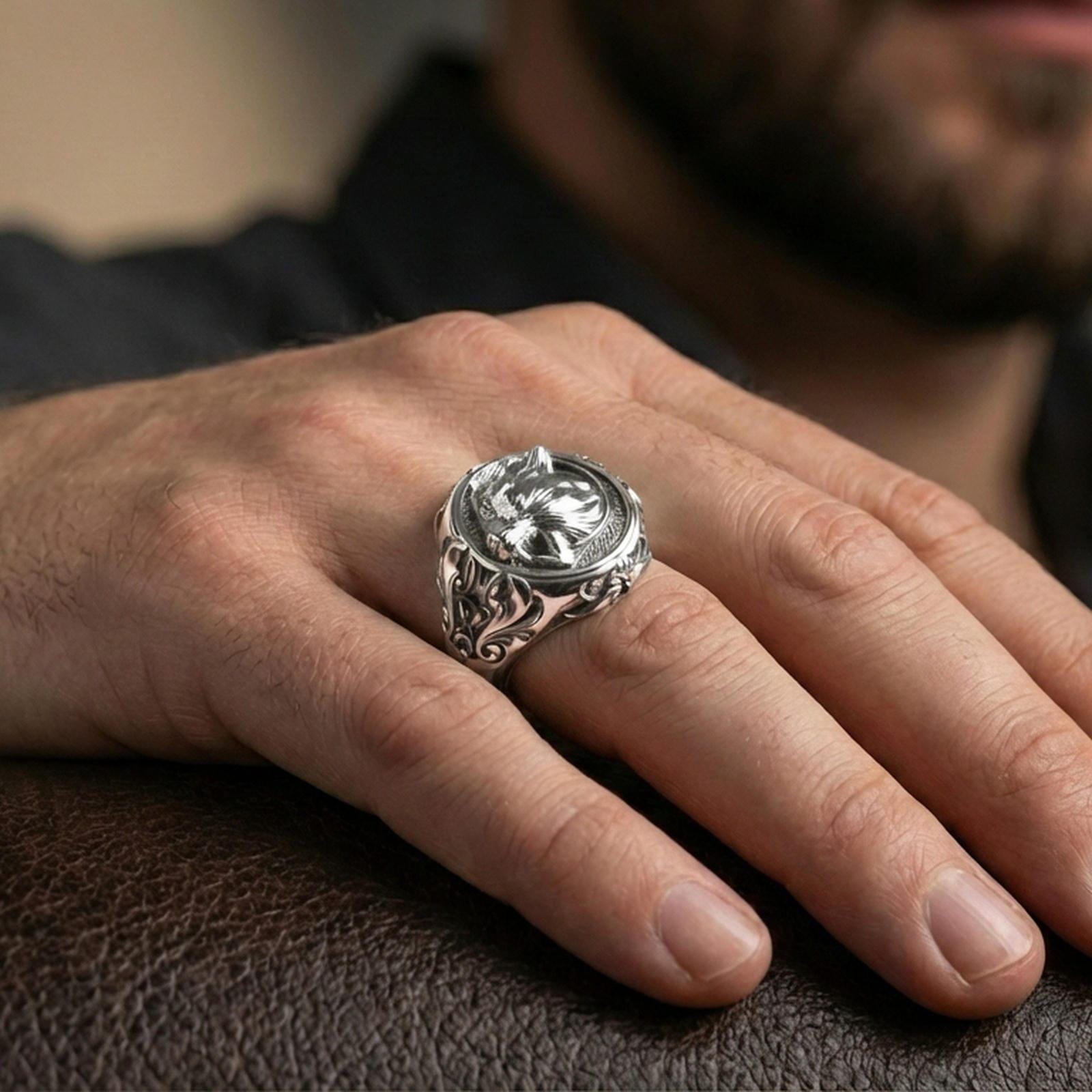 Fenrir wolf signet ring in polished silver finish on finger, Norse mythology wolf portrait design, natural lifestyle wear shot